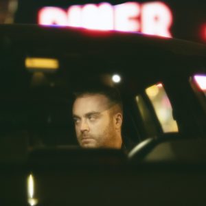 man-sitting-car-night